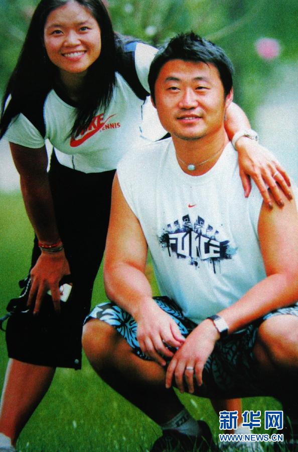 With husband and former coach Jiang Shan. Check out the long hair...