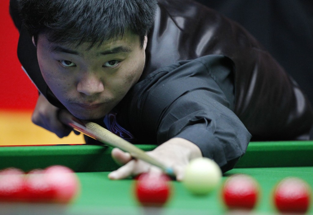 China's Ding plays a shot during his match against Williams of Wales in the final of the 2010 World Snooker China Open in Beijing