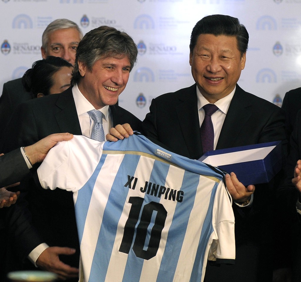 China's President Xi Jinping receives an Argentine soccer jersey with his name on it from Argentina's Vice President Amado Boudou in Buenos Aires